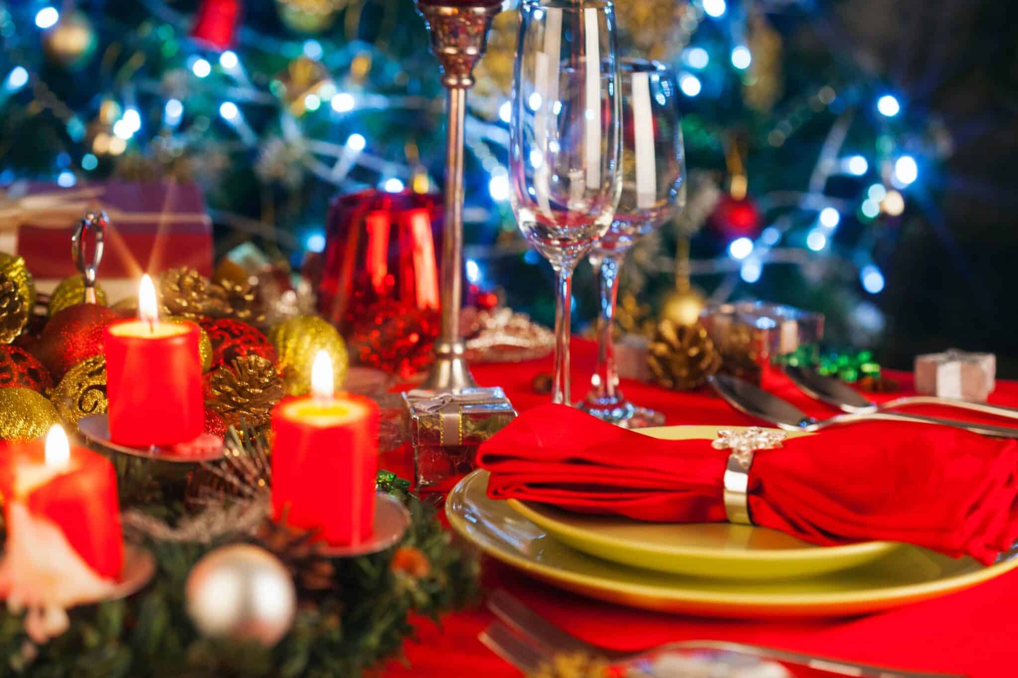 champagne glasses with christmas decorations next to it