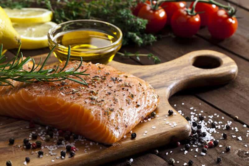 salmon filet on a wood cutting board