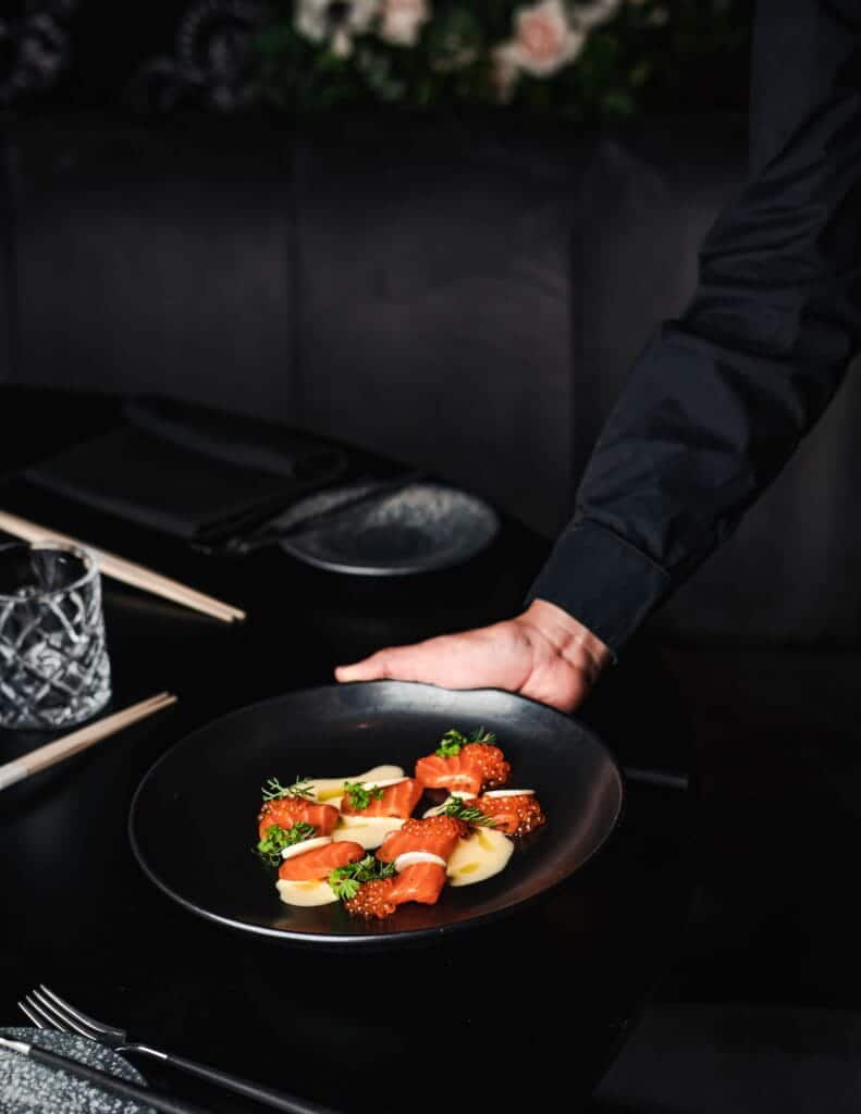 server holding plate of tuna