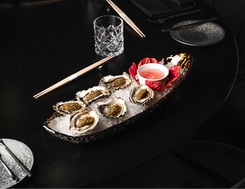 A plate of oysters and caviar from Aqua Seafood & Caviar Restaurant In Las Vegas.