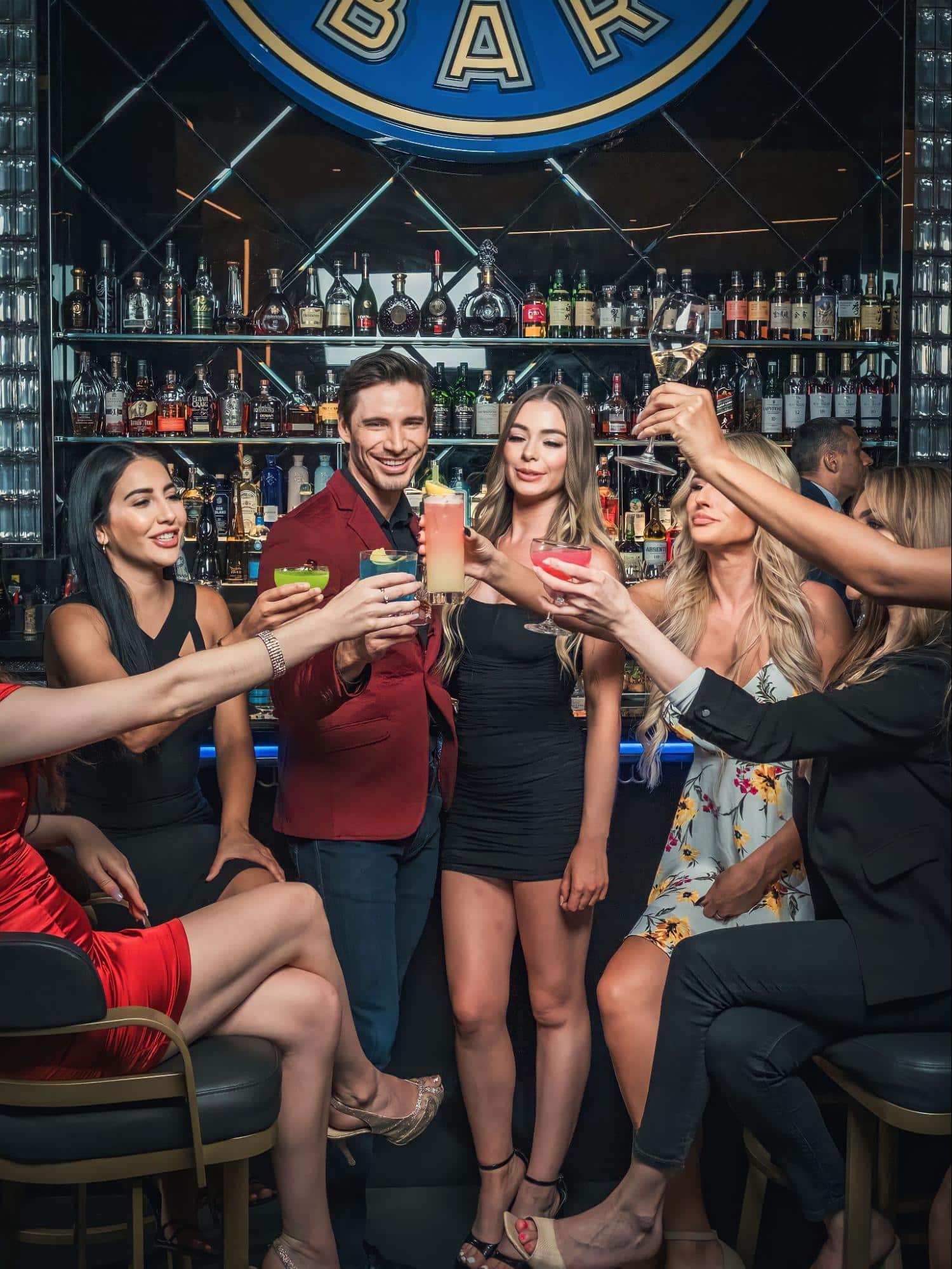 A group of friends giving a toast at Aqua Seafood & Caviar Restaurant.